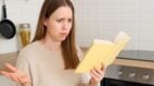 confused woman, oven fail, cooking disaster